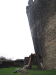 SX33190 Wooden man holding up Caerphilly Castle tower.jpg